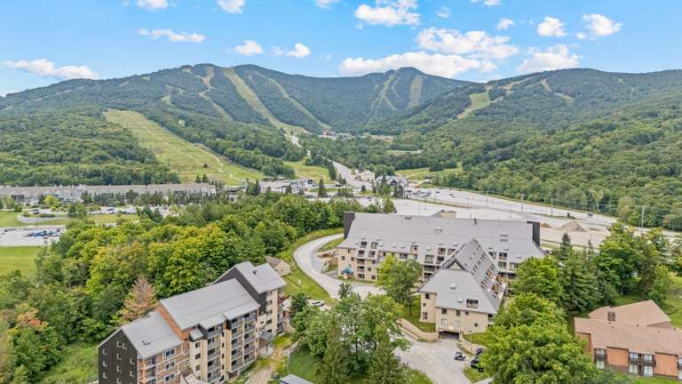 The aerial view places the resort below Killington's green summer slopes.