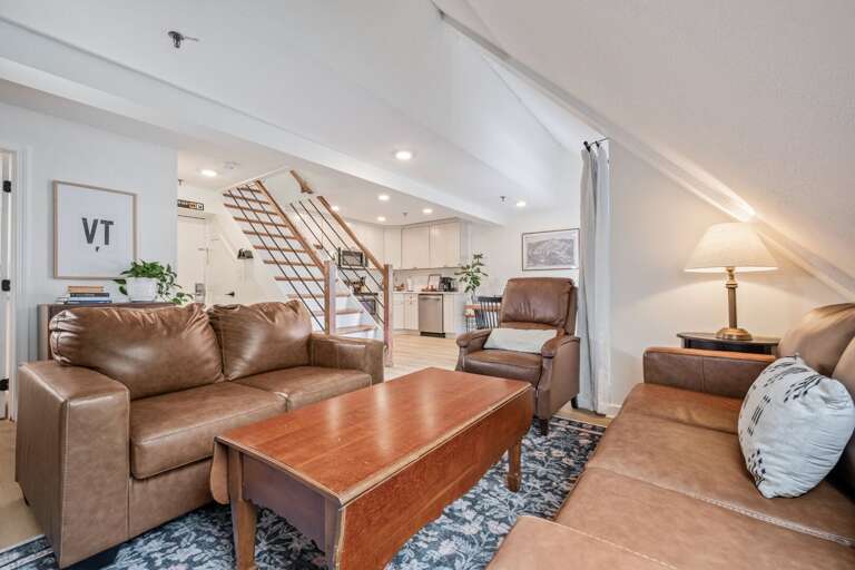 The living room stays open to the kitchen, so no one misses the conversation.