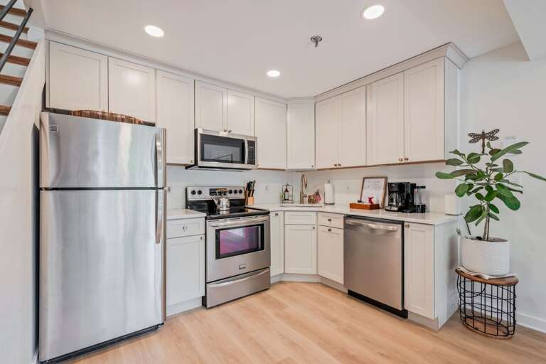 White cabinetry, stainless appliances, and clear counters keep cooking simple between mountain outings.