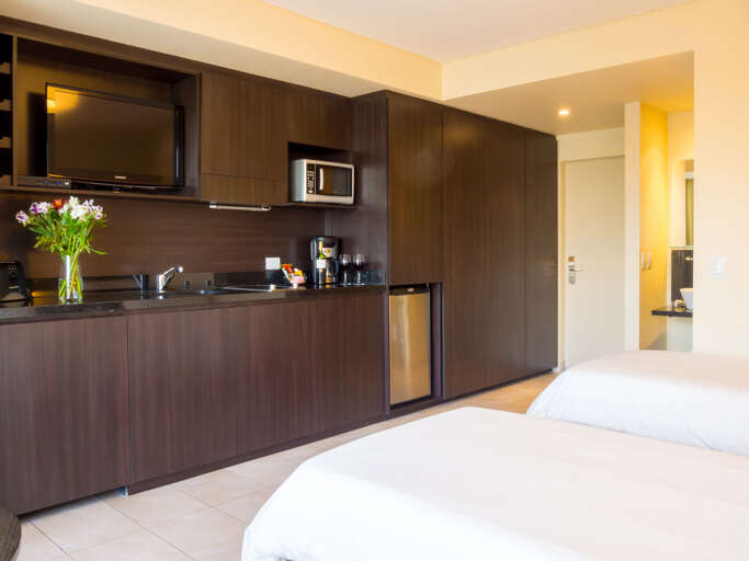 Room set up with two twin beds.