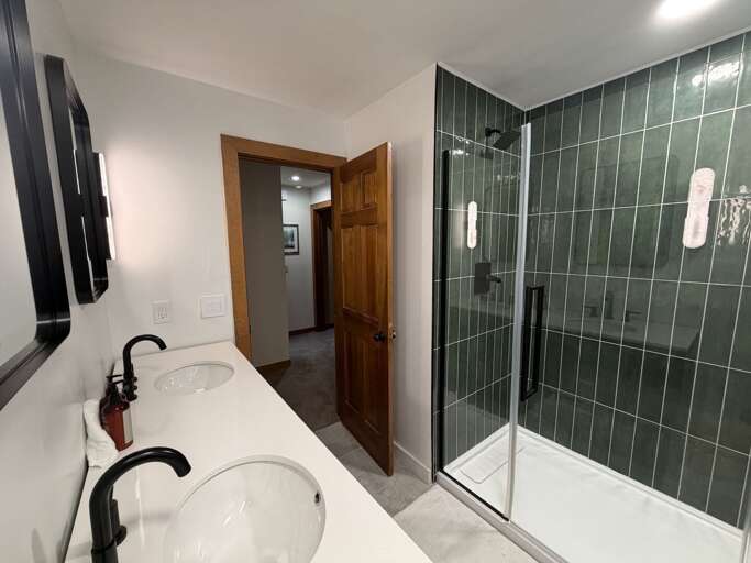 The double vanity and cabinet storage keep bathroom essentials together.