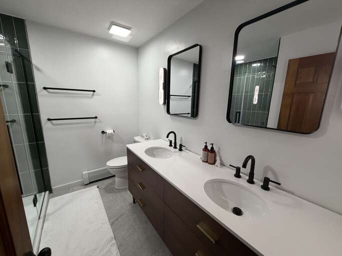 The long double-sink vanity provides space to set out toiletries near the sink.