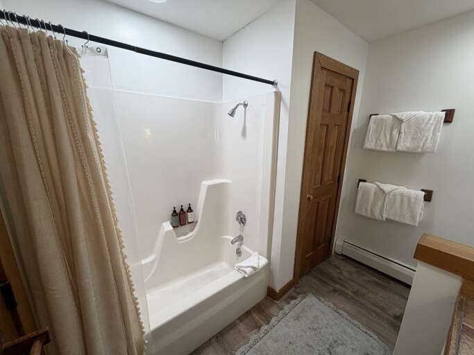 The tub-shower sits opposite the vanity for an easy morning routine.