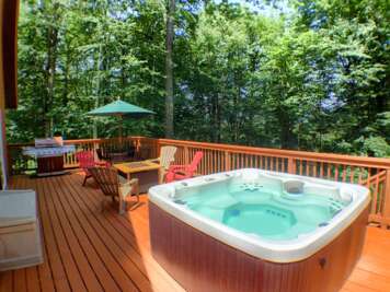 Outdoor deck of our 3-floor home in Killington, featuring tables and seating, a barbeque grill and a