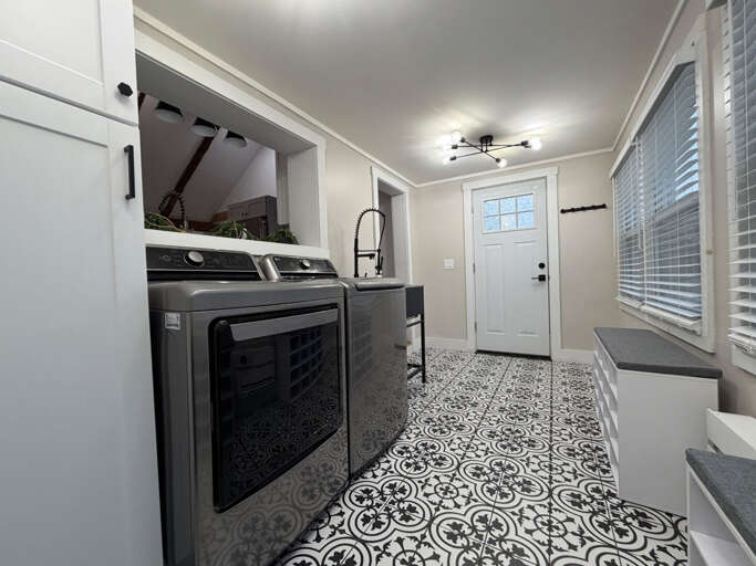 A professional deep-basin utility sink and patterned tile make post-mountain cleanup efficient and easy.