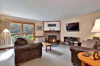 This cozy condo in the Trail Creek complex in beautiful Killington, VT, features a welcoming living space with a fireplace.