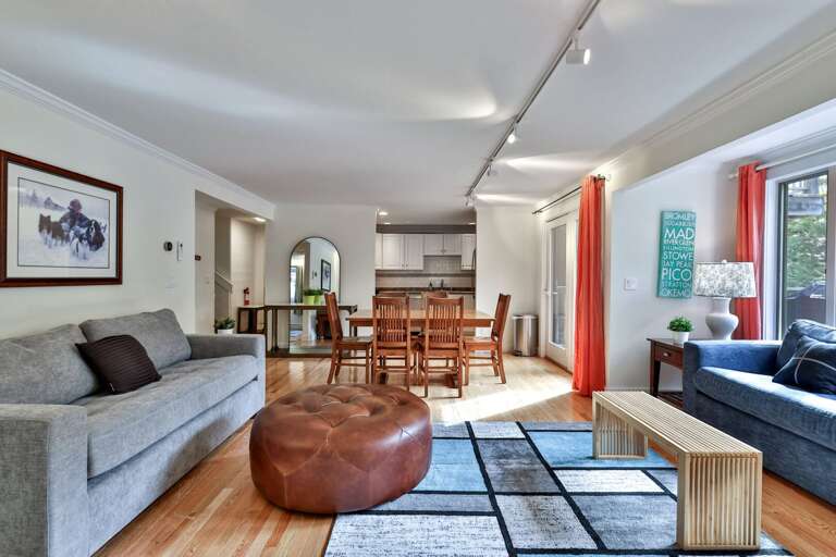 Move from dinner to the sofas without leaving the conversation, with the kitchen just beyond the dining table.