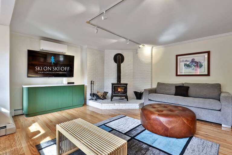 Pick a spot on the sofa for a fireside movie; the TV and wood-burning stove share this corner of the living room.