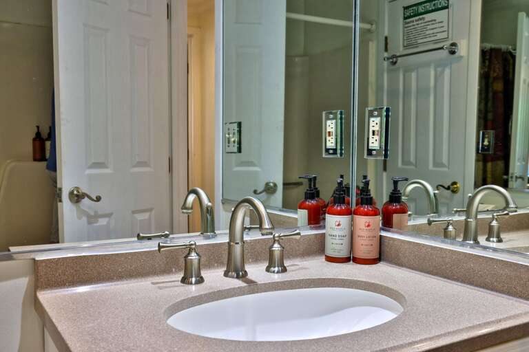 Set out your toiletries beside the sink, with a broad mirror above the vanity.