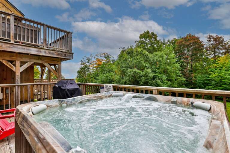 Soak on your private deck with trees beyond the railing. A setup fee applies outside peak ski-season weekends.