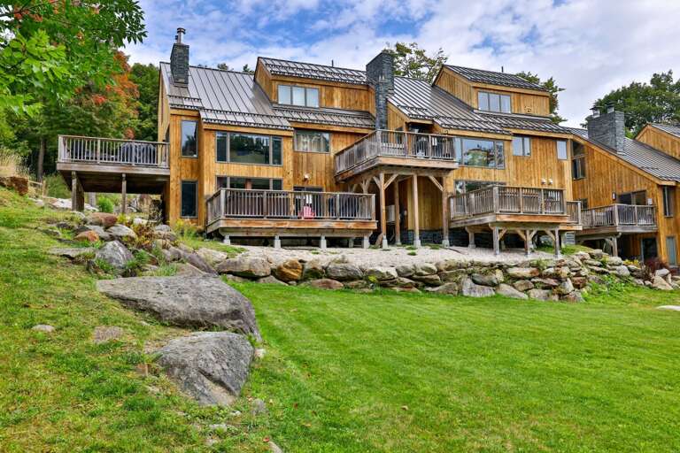 Wood siding, broad decks and a tree-lined lawn set the scene around the Trailside Village condos.