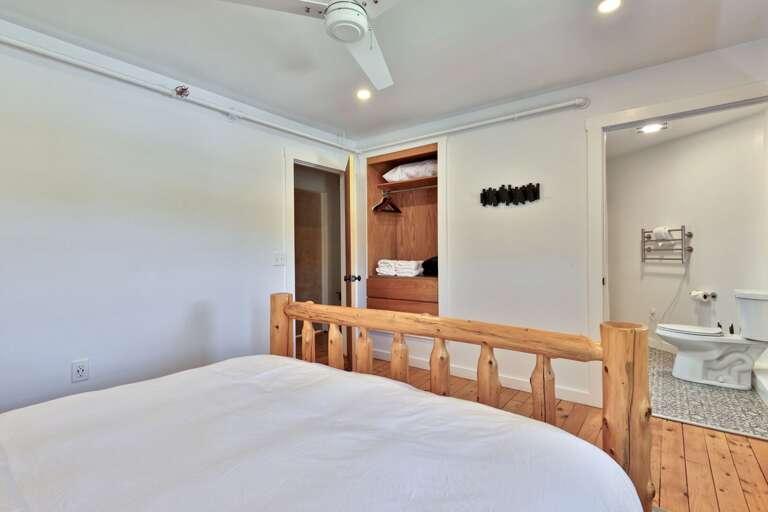 The bedroom opens directly toward its bathroom and built-in storage area.