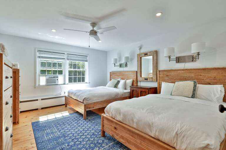 Two beds let friends or family share a bright room with windows on two sides.