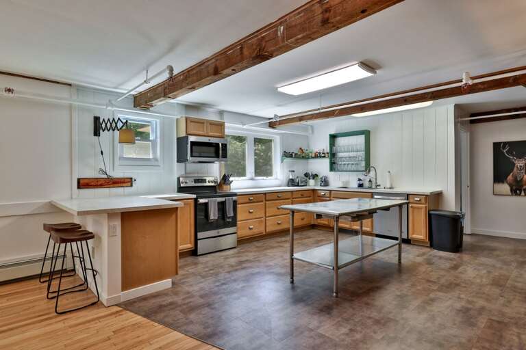 A broad kitchen work area gives the group room to prep meals without crowding the dining space.