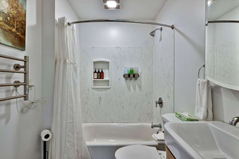 Choose a quick shower or a soak in the tub in this bright upstairs bathroom.