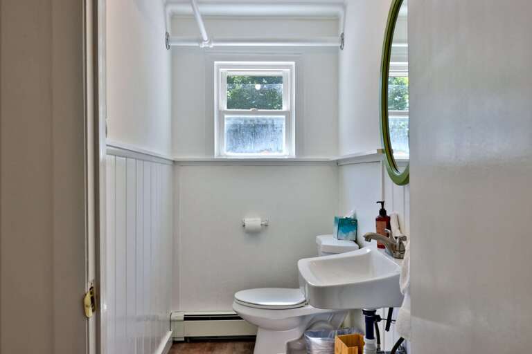 A convenient half bath serves the shared spaces on the main floor.