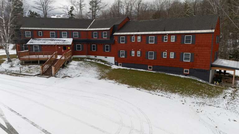 From above, the full scale of the lodge stands out against the snow-covered grounds.