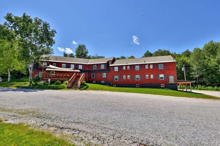 The long front elevation shows the scale of the lodge and its multiple outdoor entry points.
