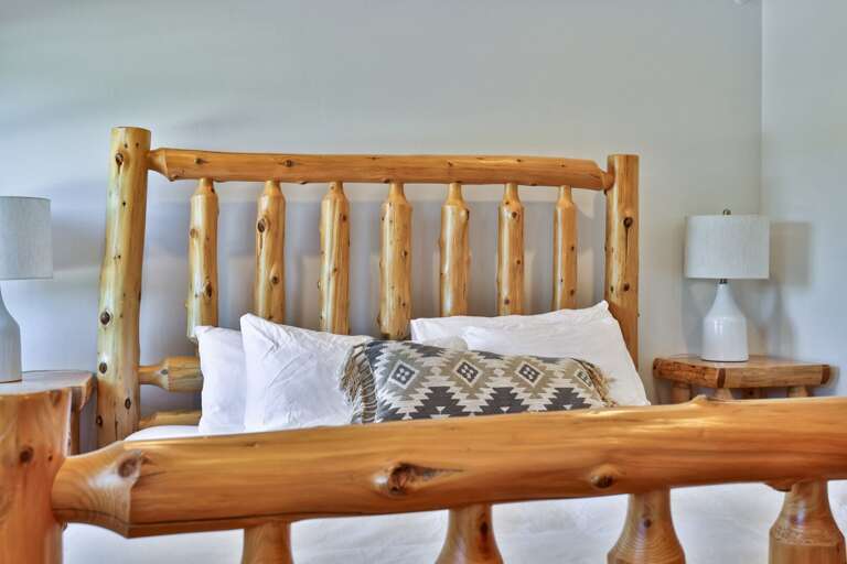 Matching nightstands and bedside lamps keep books and devices close after lights out.