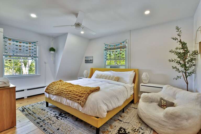 Multiple beds make this bright room a practical choice for guests who want to stay together.