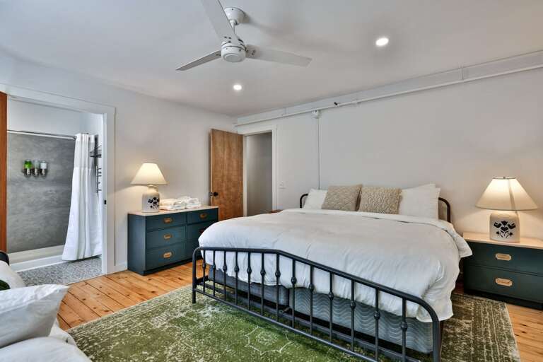 Two nightstands, open floor space, and nearby bathroom access make this room easy to settle into.
