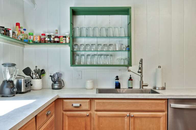 A separate prep sink and open shelving make it easier to serve drinks and meals for a crowd.
