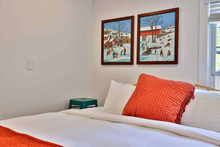 A simple, comfortable setup gives guests a calm place to recharge upstairs.