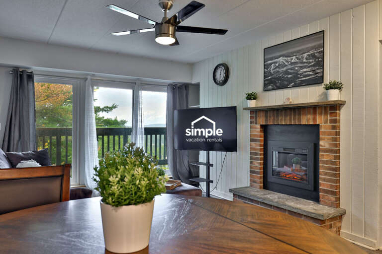 Breakfast, dinner, and a late-night card game all happen within sight of the fireplace and balcony.