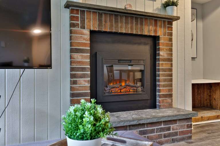 Chilly evenings feel better with the fireplace glowing beneath the movie.