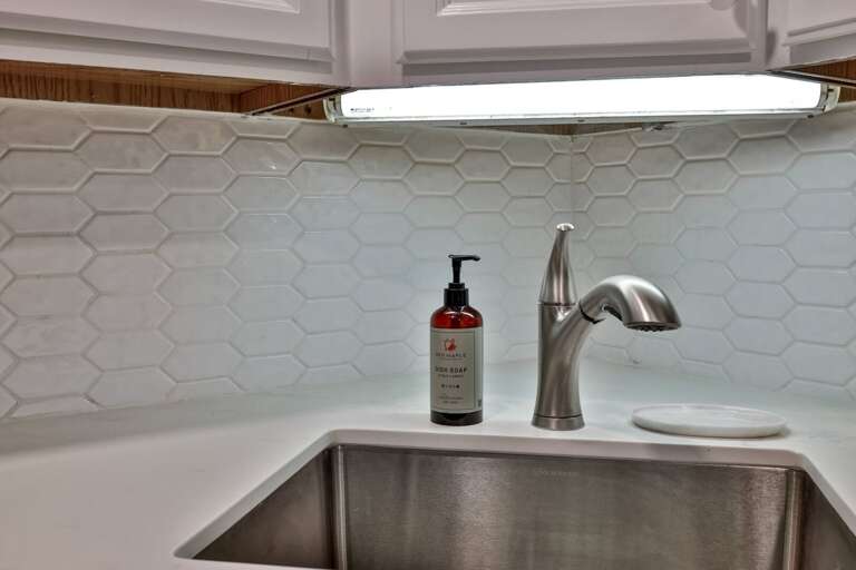 A long counter and deep sink leave room to chop, serve, and clean up without crowding the kitchen.