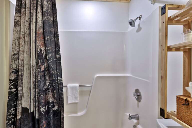 The second bathroom includes a full tub with an overhead shower and curtain.