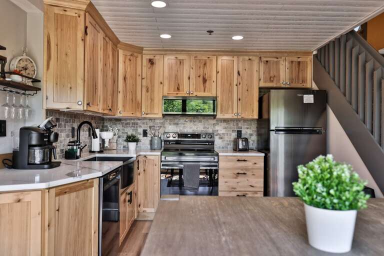 Cook at home in a full kitchen with generous cabinet space and room to prepare meals together.