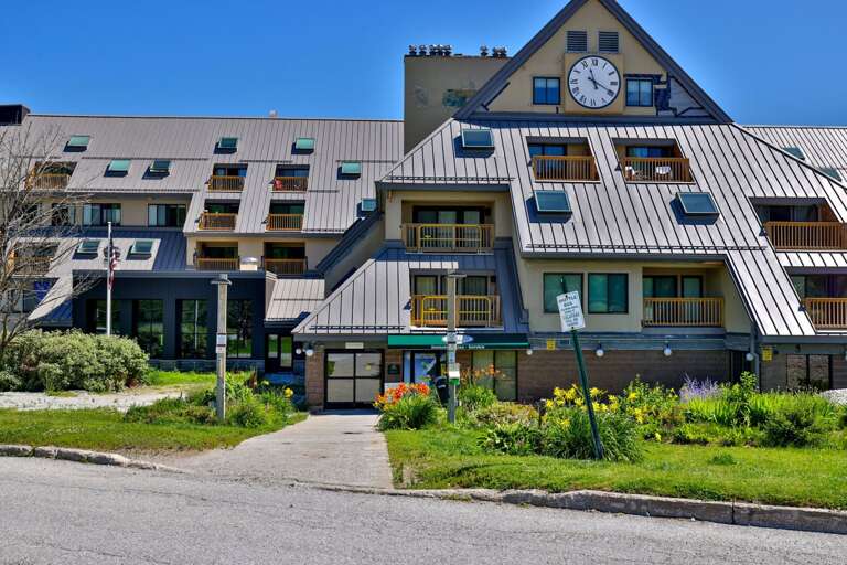 The distinctive clock-tower entrance makes the Mountain Green building easy to recognize on arrival.
