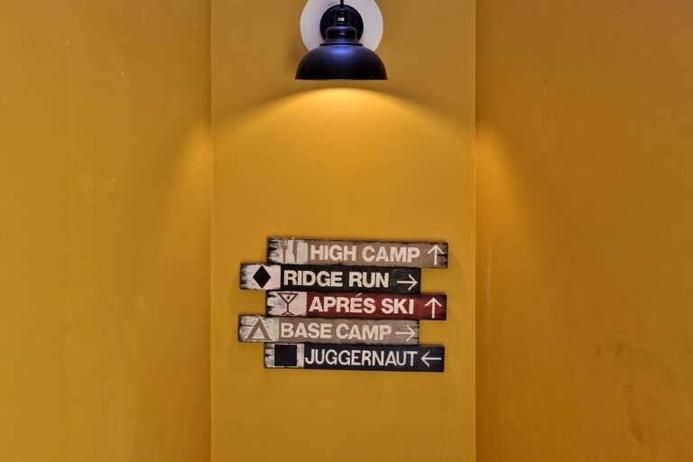 A playful trail sign brings Killington mountain character into the condo hallway.