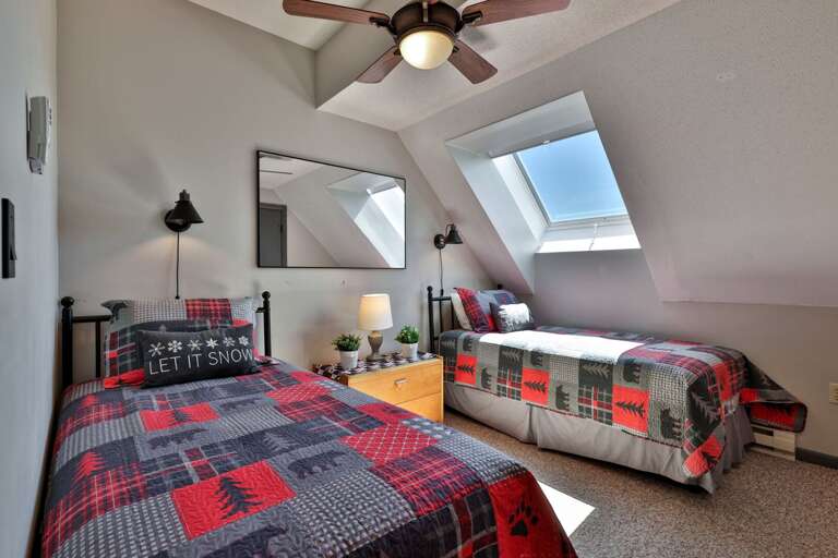 Two separate beds make this bright room a practical setup for friends or family sharing the condo.
