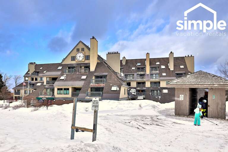 Snow, skis, and the shuttle stop set the scene for a classic Killington morning.