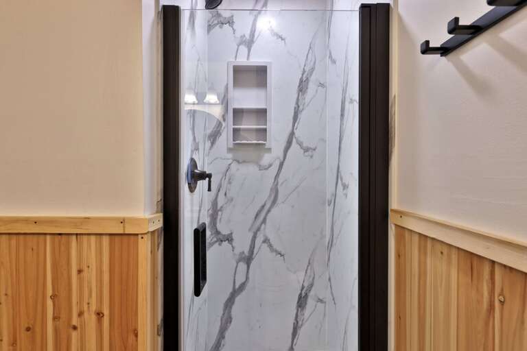 The tiled walk-in shower offers a straightforward place to rinse off and reset.