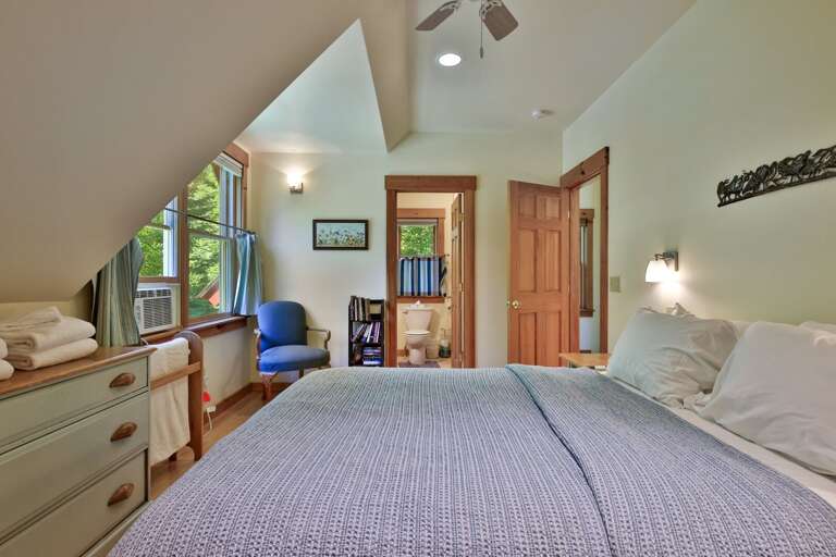 The bedroom places dresser storage and the full bathroom within easy reach.