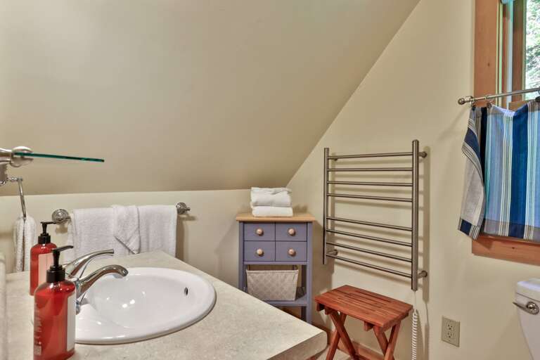 A generous vanity and heated towel rack provide useful space for getting ready.