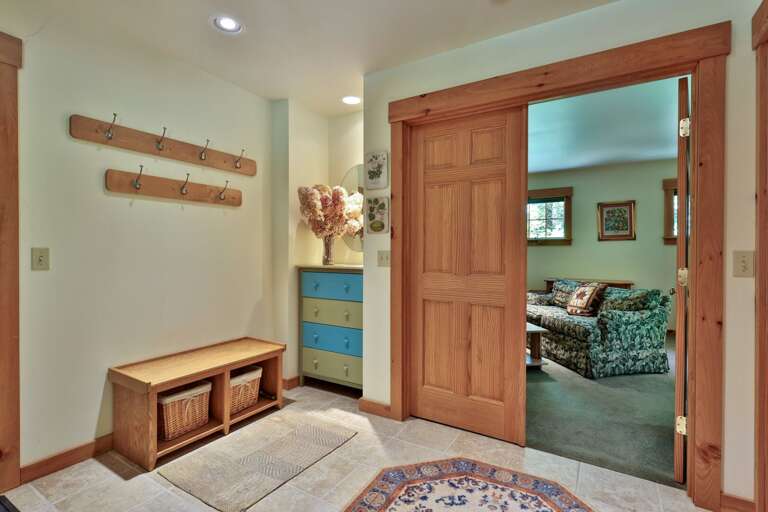 Hooks, a bench, and open floor space make this entry a practical landing zone for outdoor gear.