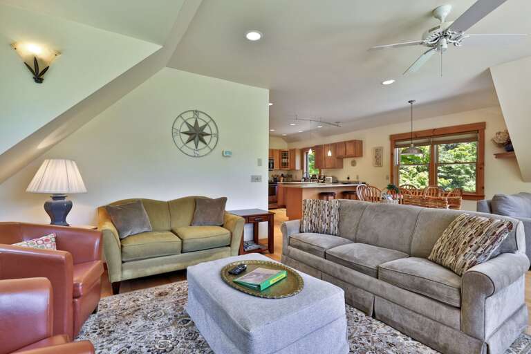 The main lounge flows toward the kitchen and dining area without sacrificing comfortable seating.