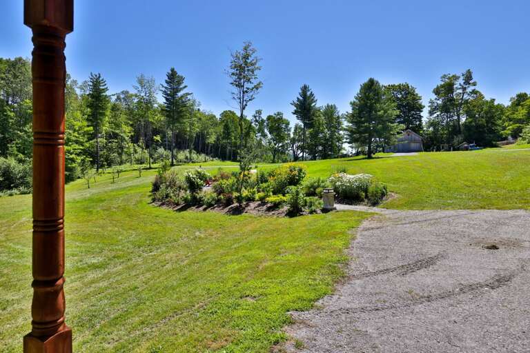 Open lawn and established gardens give the property room to breathe in every direction.