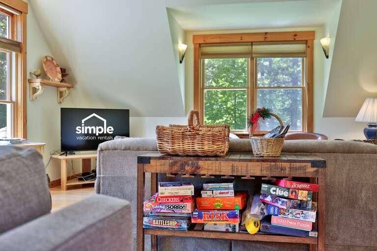 A shelf stocked with board games makes it easy to plan a low-key evening indoors.