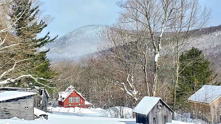 A snowy view from the property stretches across the valley toward the mountain ridgeline.
