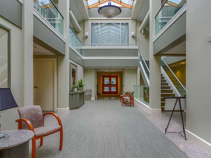 The airy atrium links reception with the pool, fitness, and wellness areas.