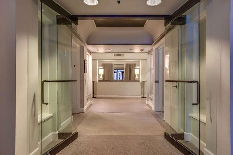 The atmosphere quiets as the corridor reaches the private spa rooms.