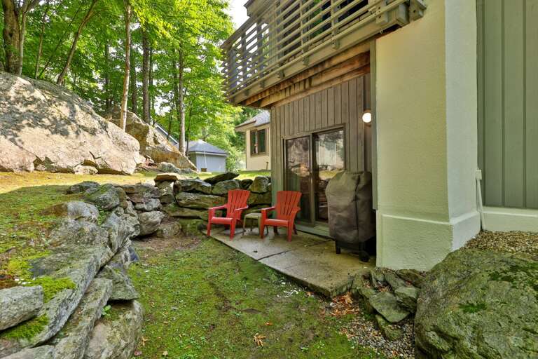 Bring coffee or a cold drink outside and take the two red chairs under the trees.