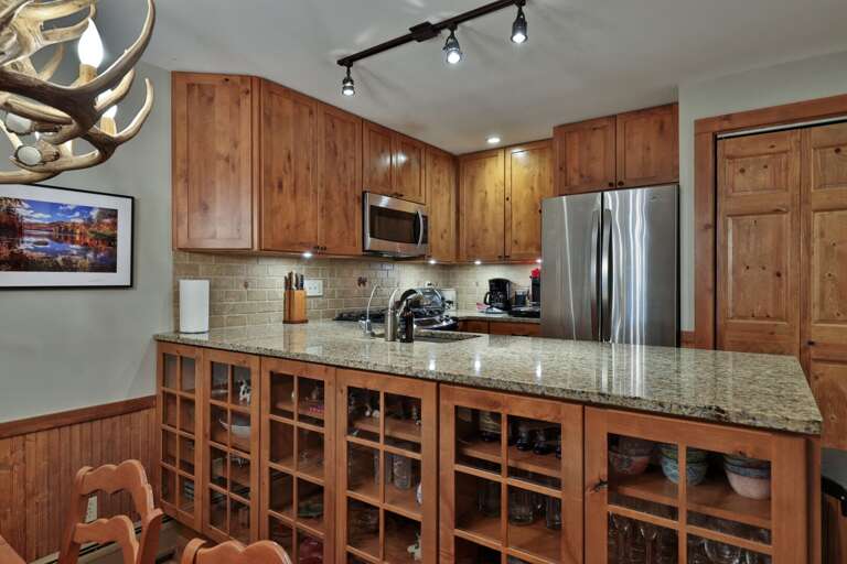 Use the broad peninsula as a buffet, with dishes and glassware stored right below.