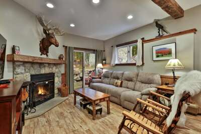 Build a real fire, stretch out on the sectional, and let the wooded patio draw Vermont into the room.