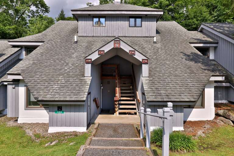 The covered approach leads into the building, with stairs continuing to the upper residences.